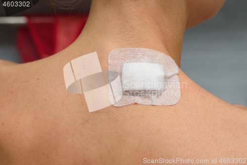 Image of Medical Patch pasted on the wound on the girl\'s neck