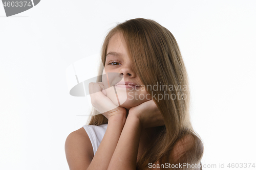 Image of Portrait of a close-up of a girl covering part of her face with her hair