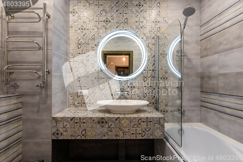 Image of The washstand and bathroom in the interior of a small and modern bathroom