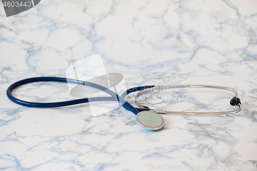 Image of Medical stethoscope or phonendoscope over light blue background