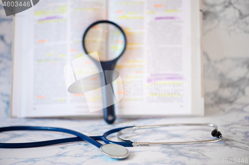 Image of Stethoscope, magnifier and book
