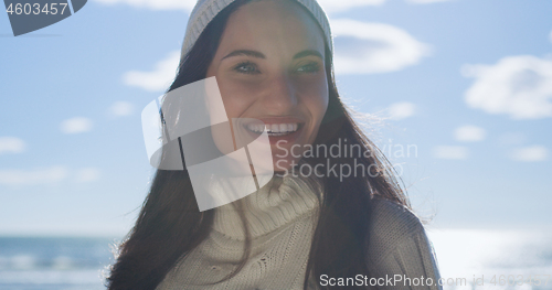 Image of Girl In Autumn Clothes Smiling on beach