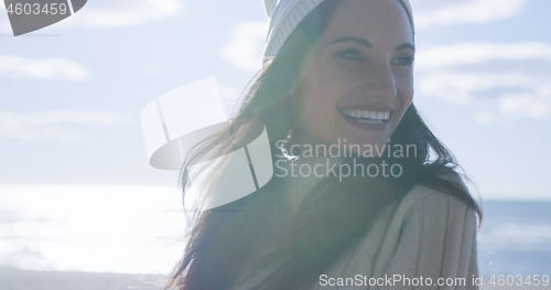 Image of Girl In Autumn Clothes Smiling on beach