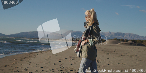 Image of Young woman enjoying the warm autumn day