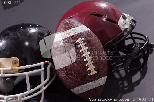 Image of american football and helmets isolated on gray