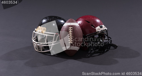 Image of american football and helmets isolated on gray