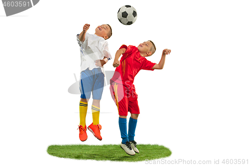 Image of Young boys with soccer ball doing flying kick