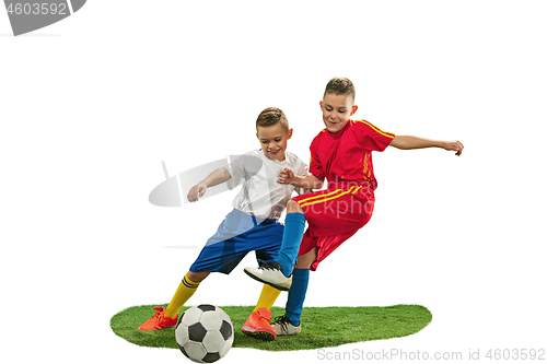 Image of Young boys with soccer ball doing flying kick