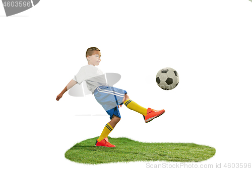 Image of Young boy with soccer ball doing flying kick