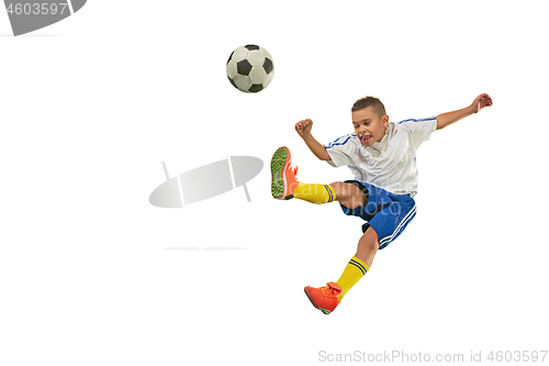 Image of Young boy with soccer ball doing flying kick