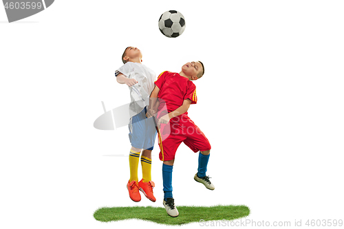 Image of Young boys with soccer ball doing flying kick