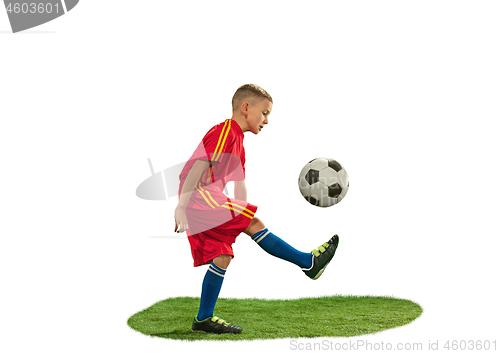 Image of Young boy with soccer ball doing flying kick