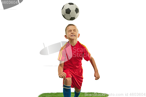 Image of Young boy with soccer ball doing flying kick