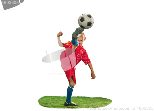 Image of Young boy with soccer ball doing flying kick