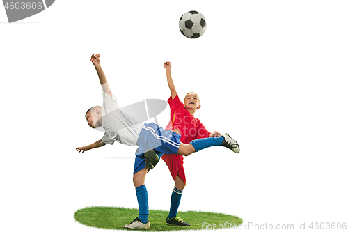 Image of Young boys with soccer ball doing flying kick