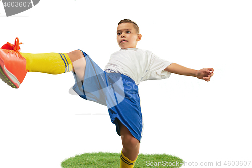 Image of Young boy with soccer ball doing flying kick