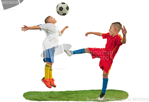Image of Young boys with soccer ball doing flying kick