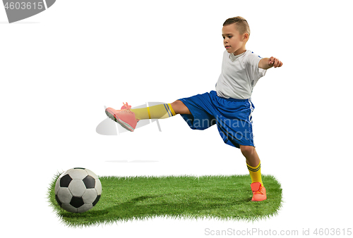 Image of Young boy with soccer ball doing flying kick