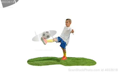 Image of Young boy with soccer ball doing flying kick