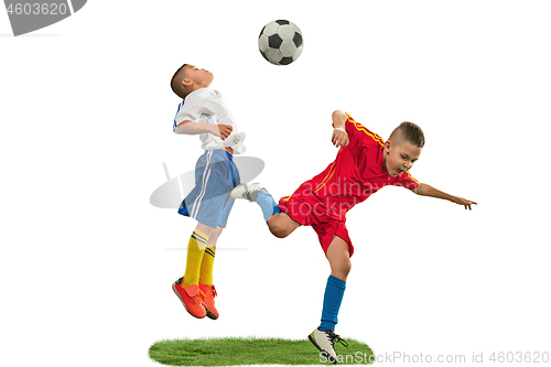 Image of Young boys with soccer ball doing flying kick