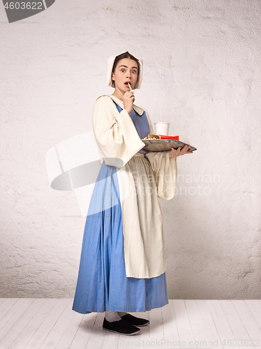 Image of Medieval Woman in Historical Costume Wearing Corset Dress and Bonnet.