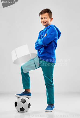 Image of smiling boy in blue hoodie with soccer ball
