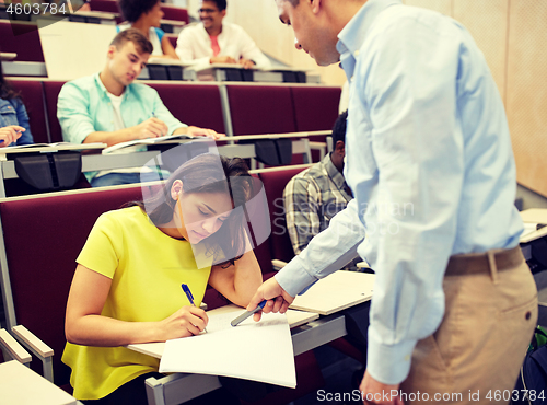 Image of group of students and teacher with notebook