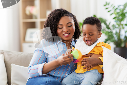 Image of mother and baby playing with ball at home