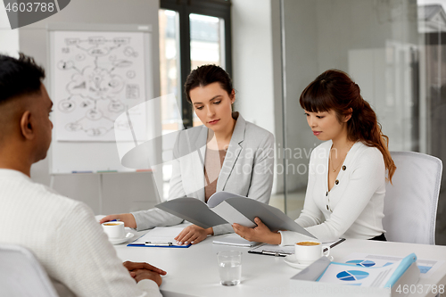 Image of recruiters having job interview with male employee