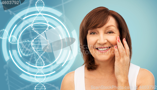 Image of senior woman touching her face over dna molecule