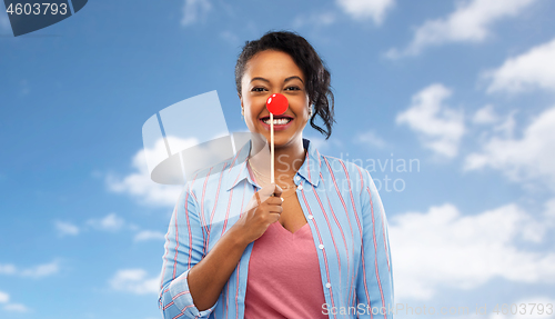 Image of happy african american woman with red clown nose