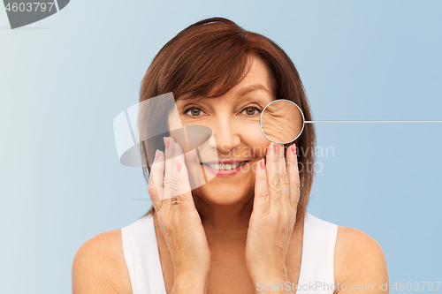 Image of senior woman with zoomed eye wrinkles in pointer