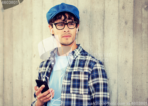 Image of man with earphones and smartphone listening music