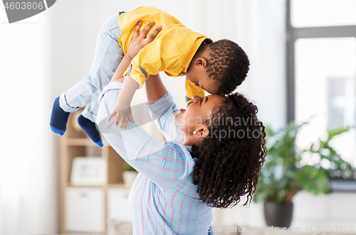 Image of happy african american mother with baby at home