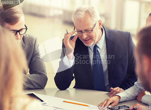 Image of architects with tablet pc and blueprint at office