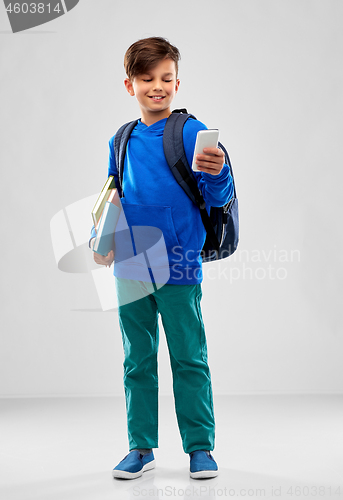 Image of student boy with smartphone, books and school bag