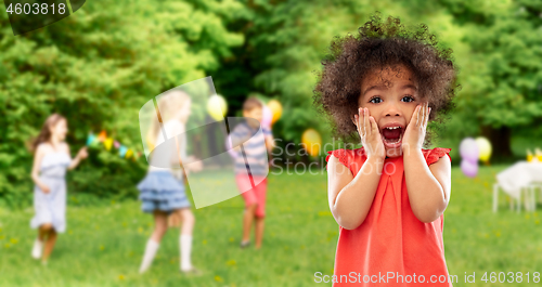 Image of surprised african american girl at birhtday party