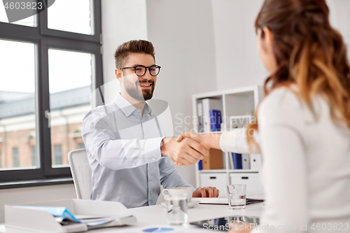 Image of recruiters having job interview with male employee