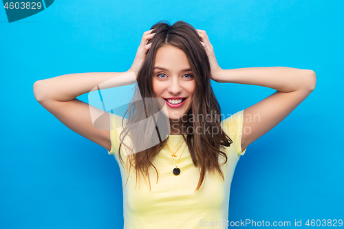 Image of young woman holding to her head