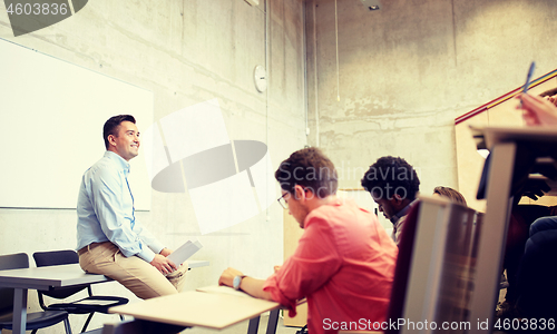 Image of group of students and teacher at lecture