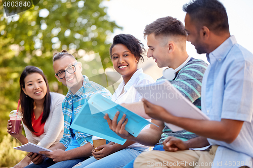 Image of group of happy students with notebooks and drinks