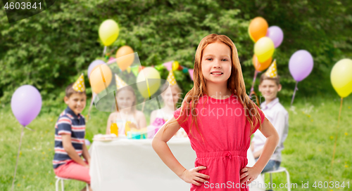 Image of smiling red haired girl at birthday party