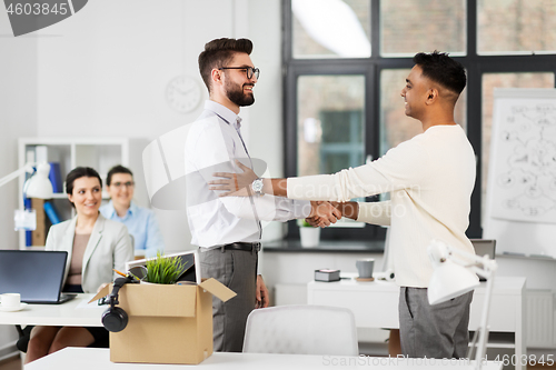 Image of new male employee meeting colleagues at office