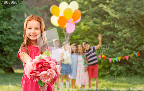 Image of red haired girl with flowers at birthday party