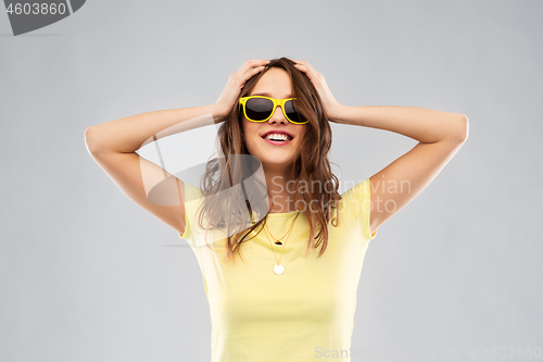 Image of teenage girl in yellow sunglasses and t-shirt