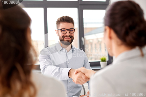 Image of recruiters having job interview with male employee