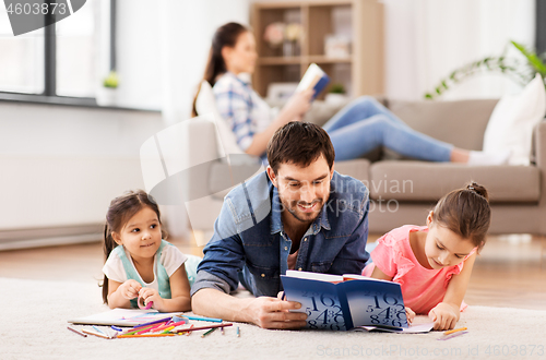 Image of father with little daughters drawing at home