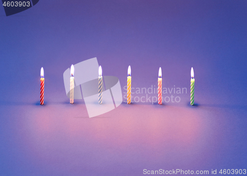 Image of Birthday composition from burning candles for sweet cakes.