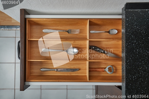 Image of Minimalist kitchen tools put away in a drawer