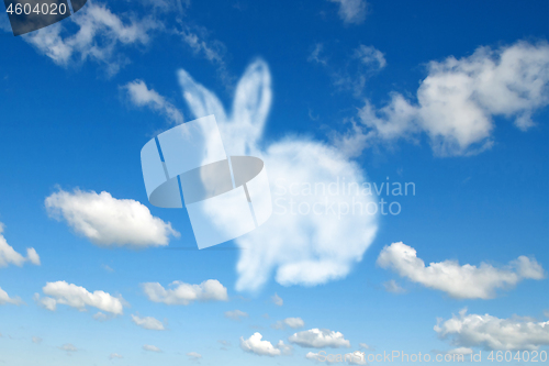 Image of Shape of fluffy cloud Easter bunny on a cloudy sky blue background.